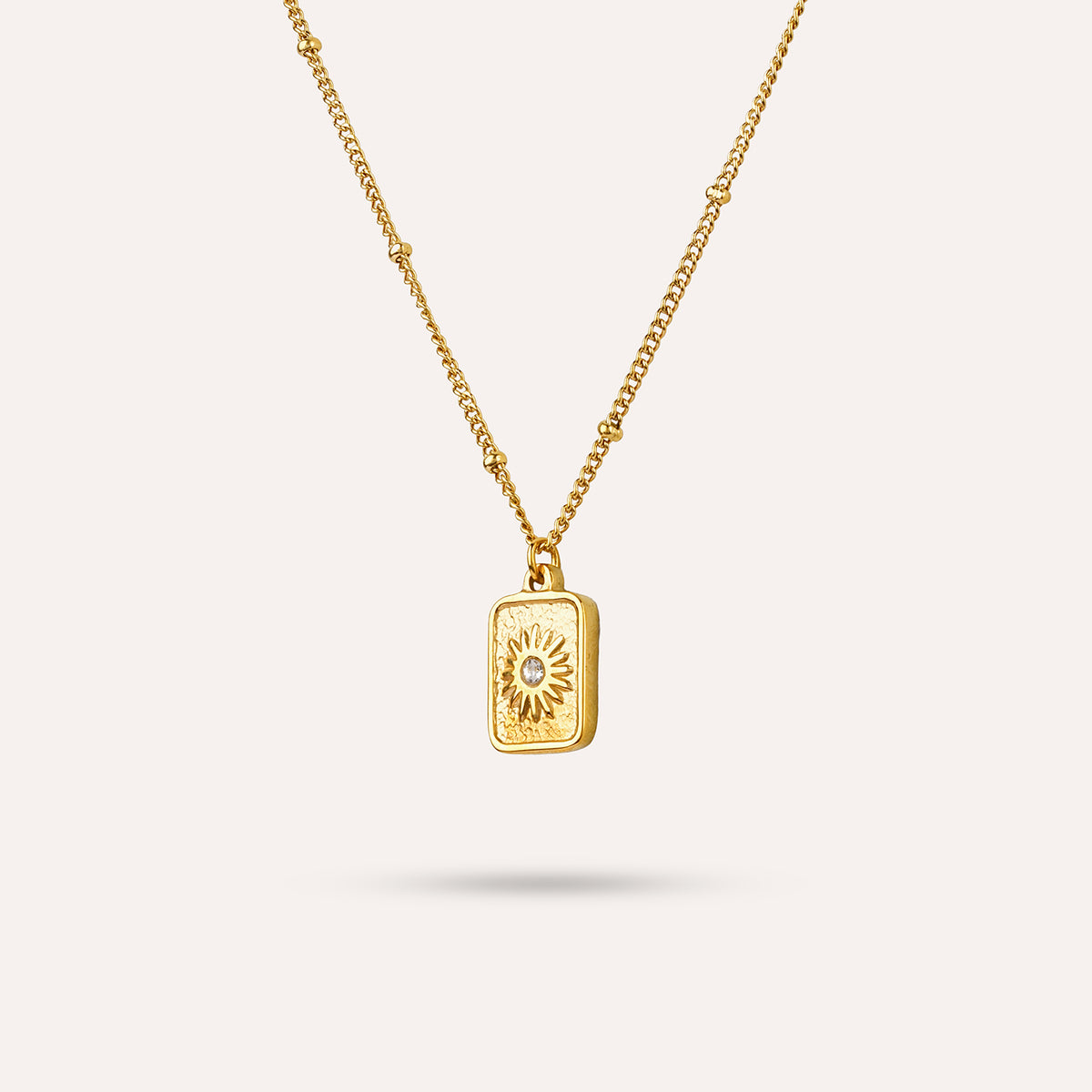 Elios Pendant Necklace | Sunburst Tag Gold-Tone Chain